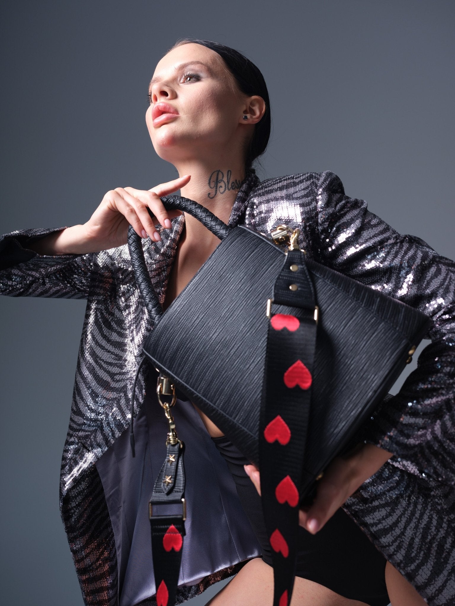Large black vegan leather bucket bag with braided handle and shoulder strap