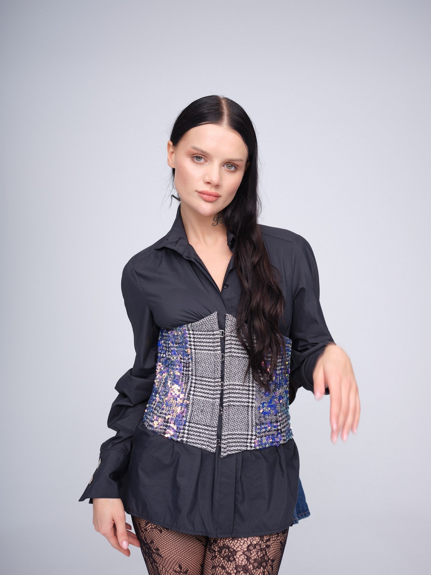 Monochrome check corset with iridescent sequins and front hook closures.