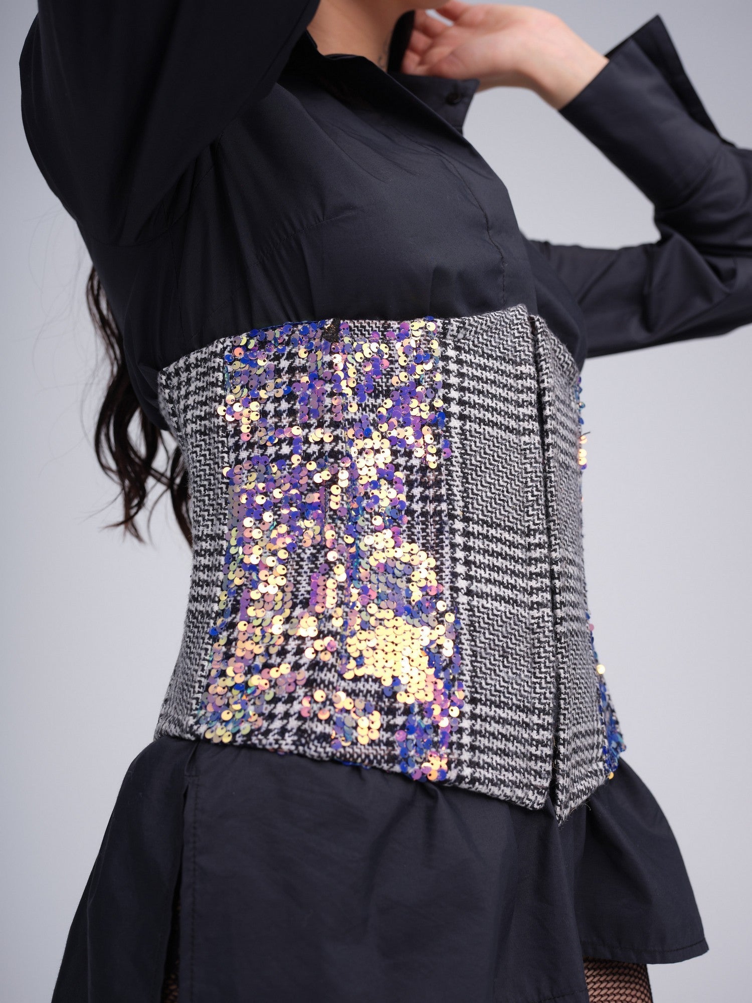 Monochrome check corset with iridescent sequins and front hook closures.