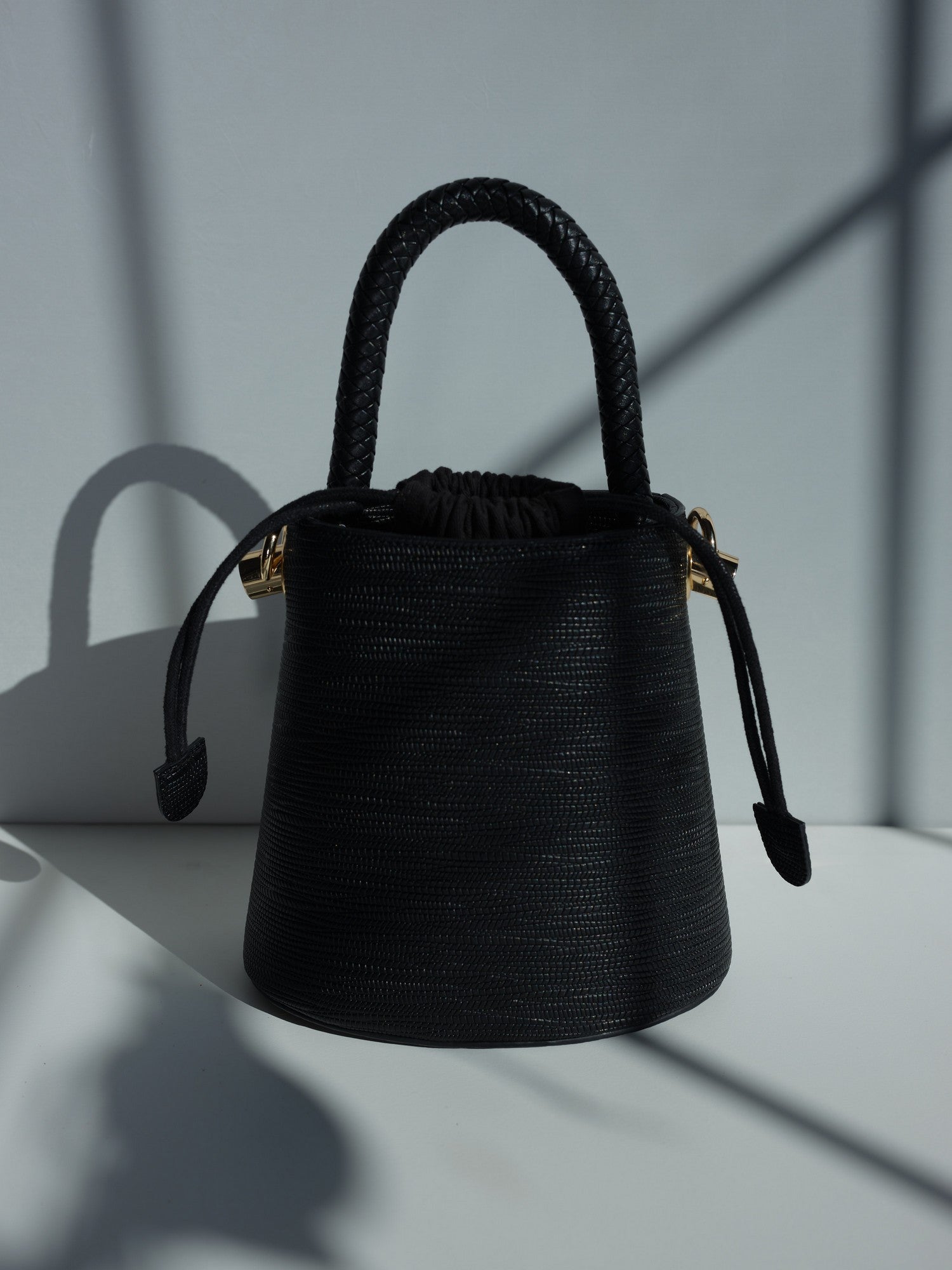 Black vegan leather bucket bag with braided handle