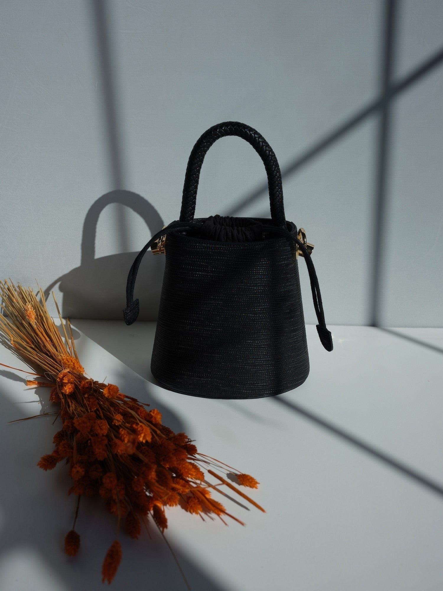Black vegan leather bucket bag with braided handle