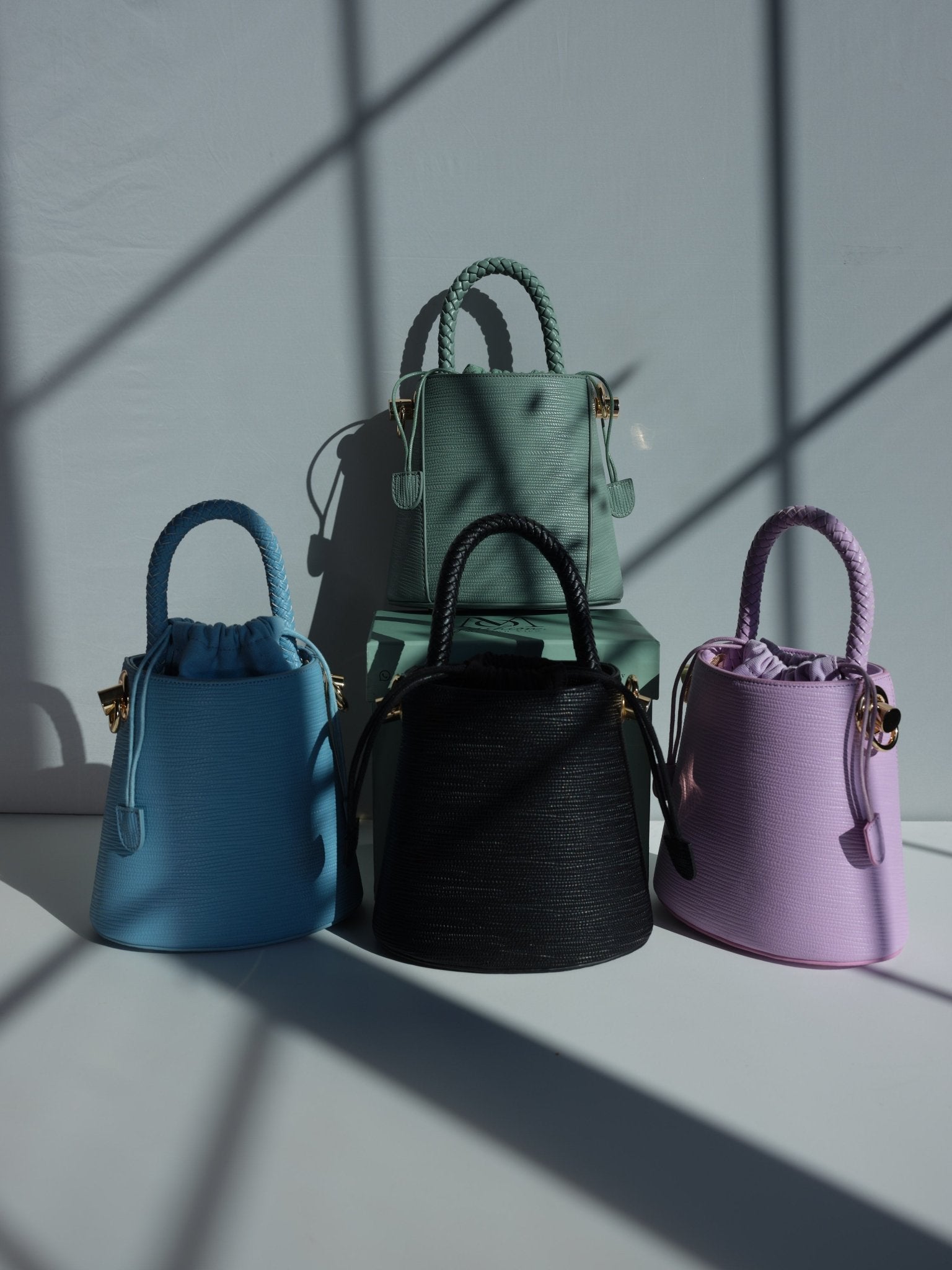 Green vegan leather bucket bag with braided handle