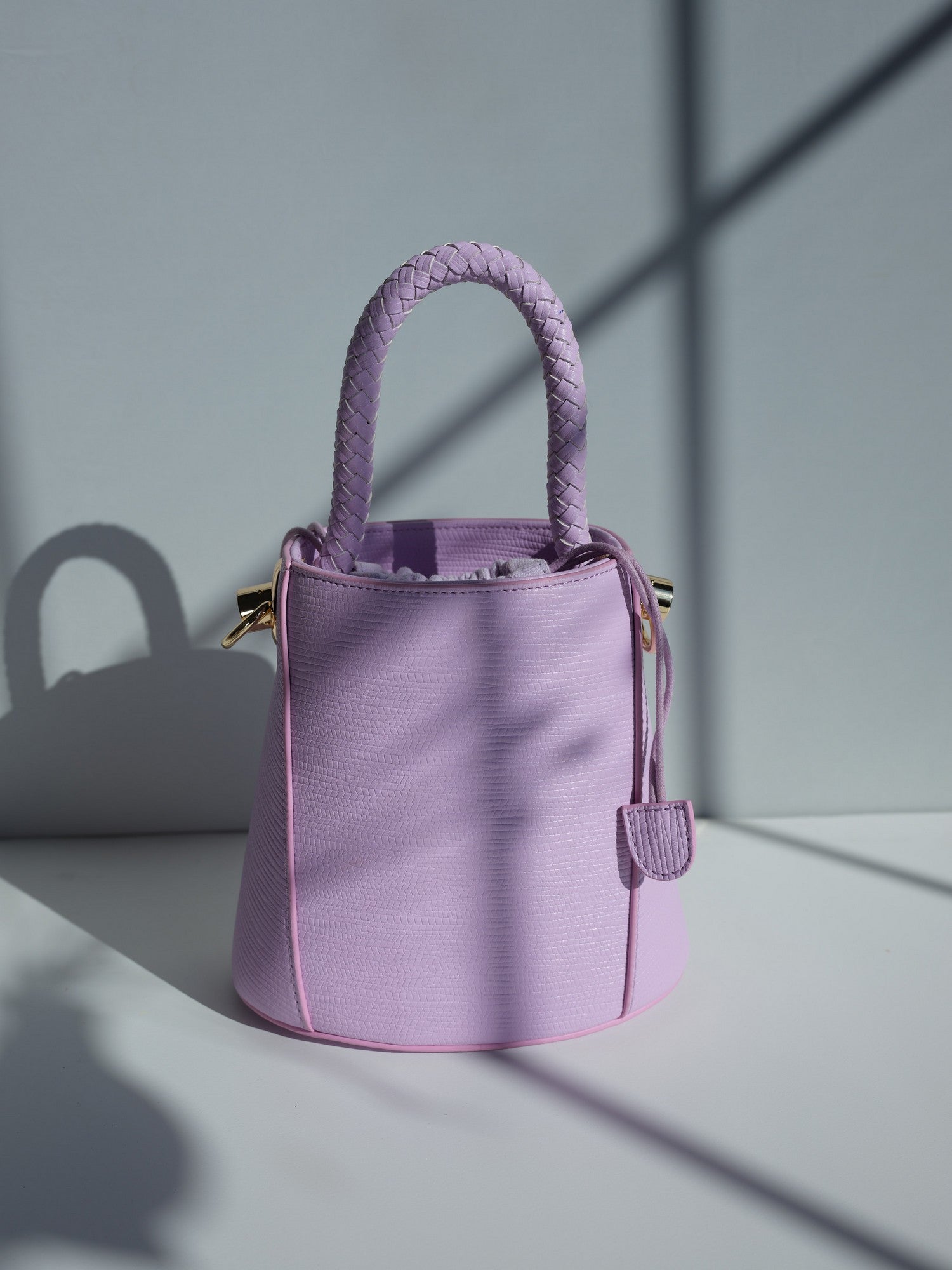 Purple vegan leather bucket bag with braided handle